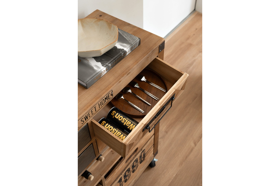 Wooden wine cabinet drawer open showing four metal spoons and two cans of soda, angled top view.