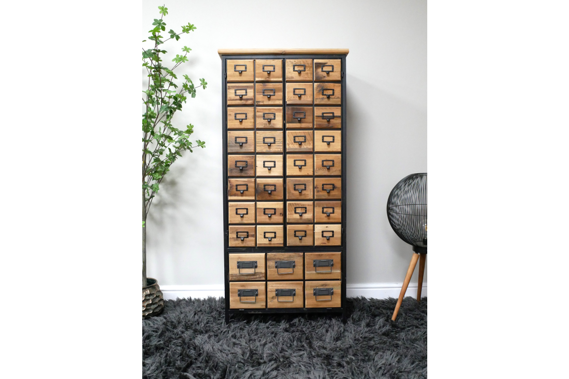 Wooden storage cabinet with multiple small drawers, black metal frame, shown front view on gray shaggy rug.