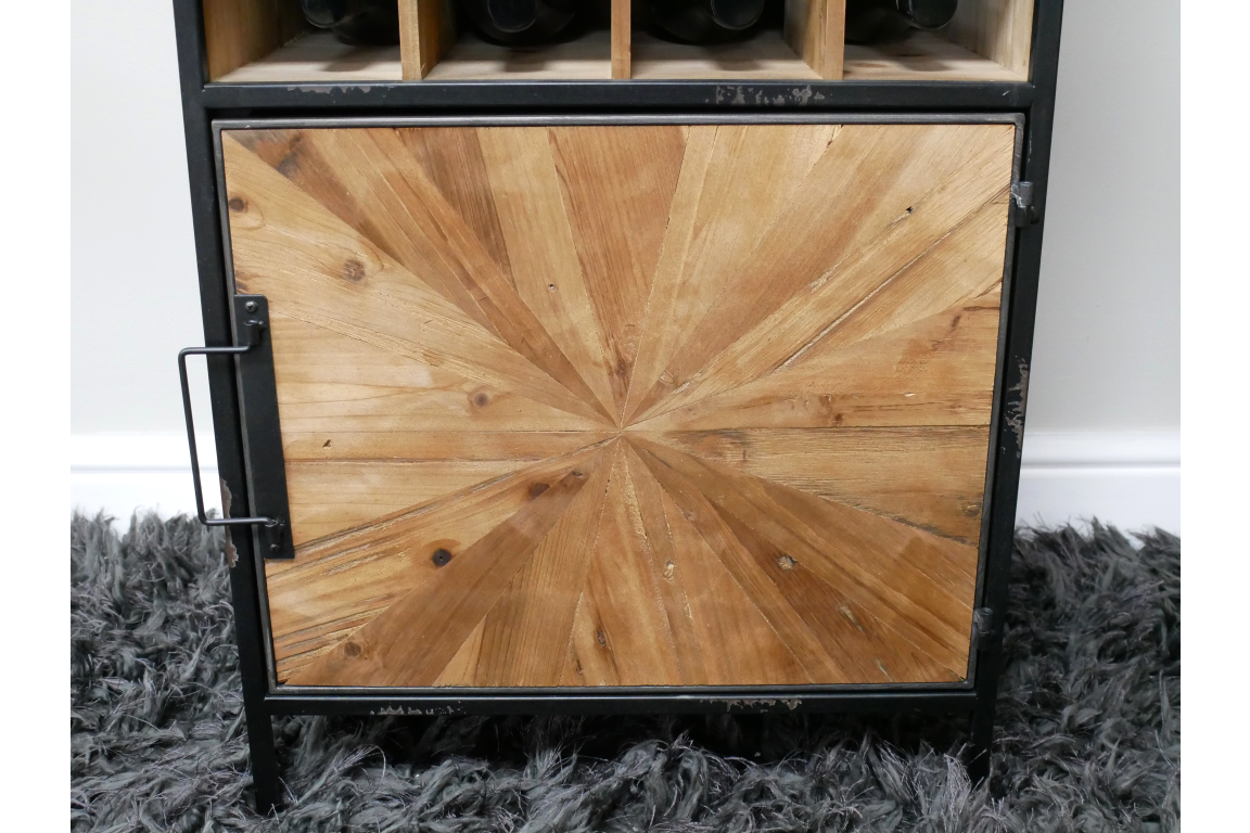 Wine cabinet with black metal frame, light wood geometric patterned door, standing on grey shaggy rug, front view.