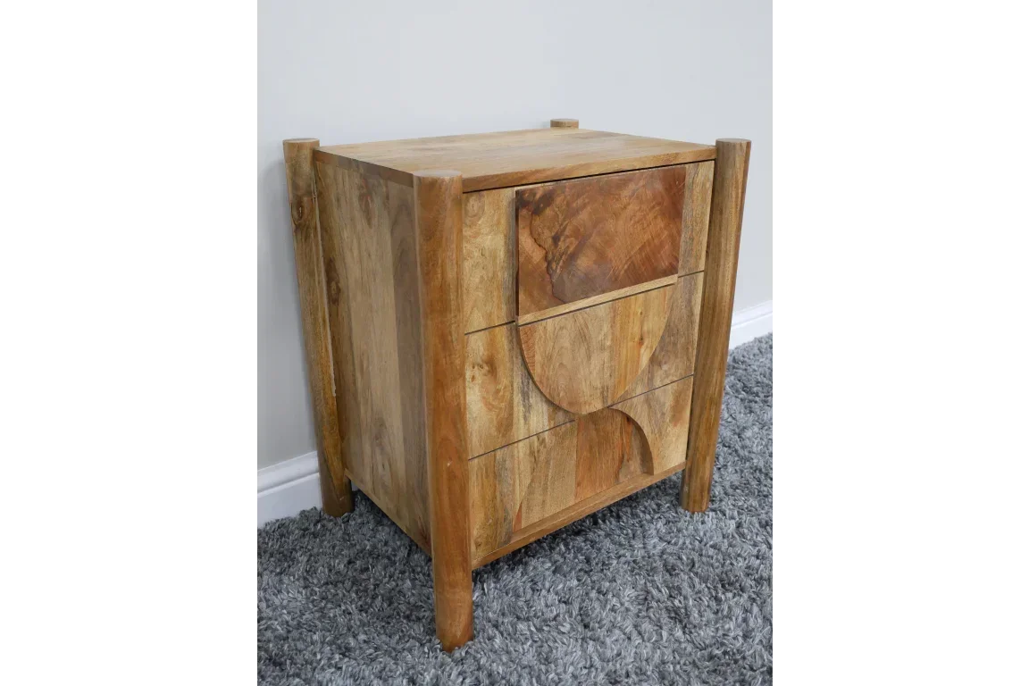 Solid wood bedside table with three drawers, geometric pattern front, on grey carpet