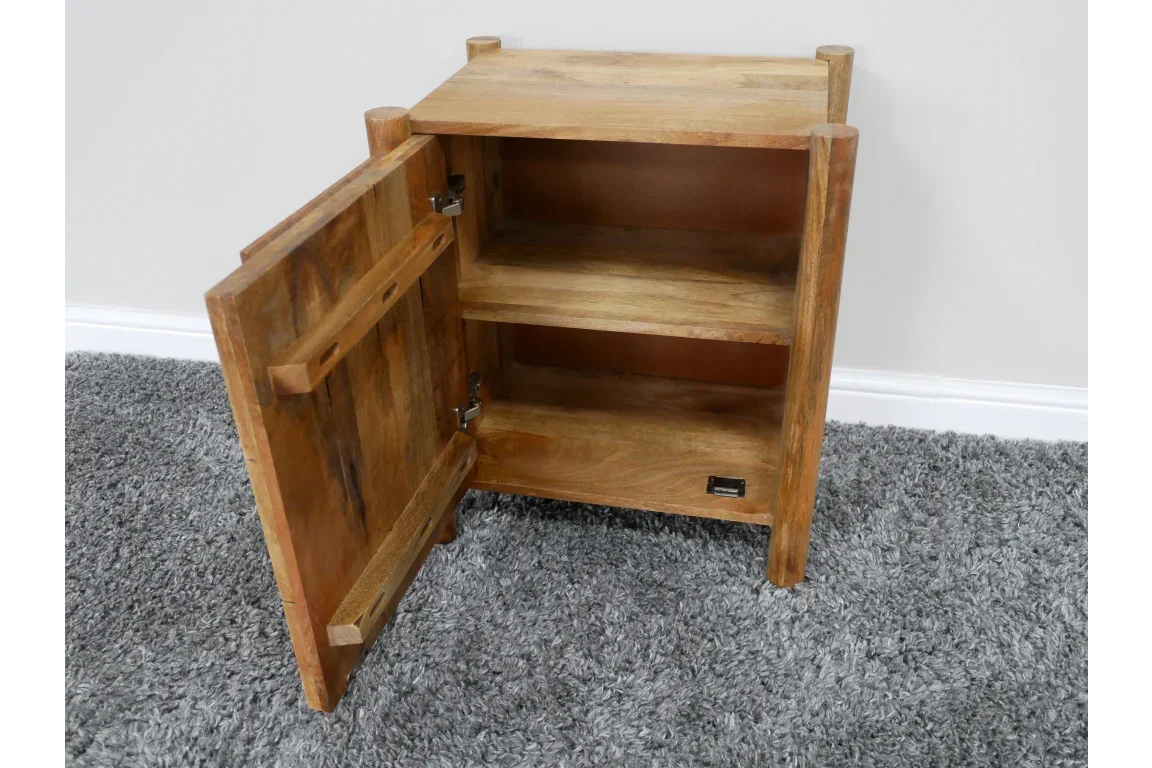 Solid wood side table with open door revealing shelves, placed on grey carpet