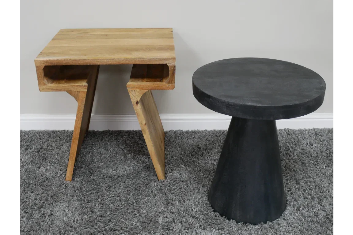 Modern wooden side table and black round accent table on grey rug