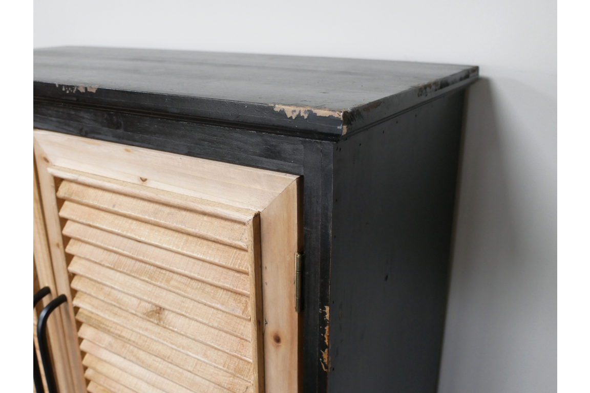 Shutter bar cabinet with distressed black wood frame and natural unfinished wooden louvered door, side angle view.