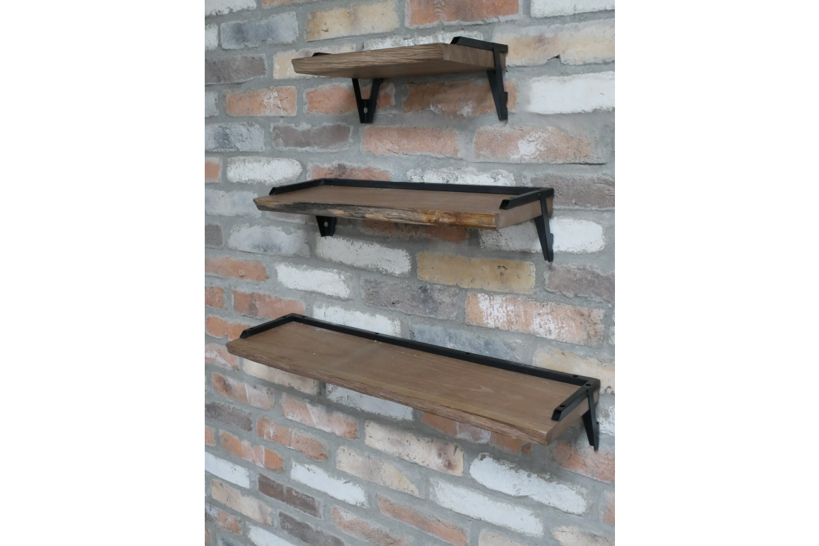 Set of 3 wooden wall shelves with black metal brackets mounted on a rustic brick wall, angled side view.
