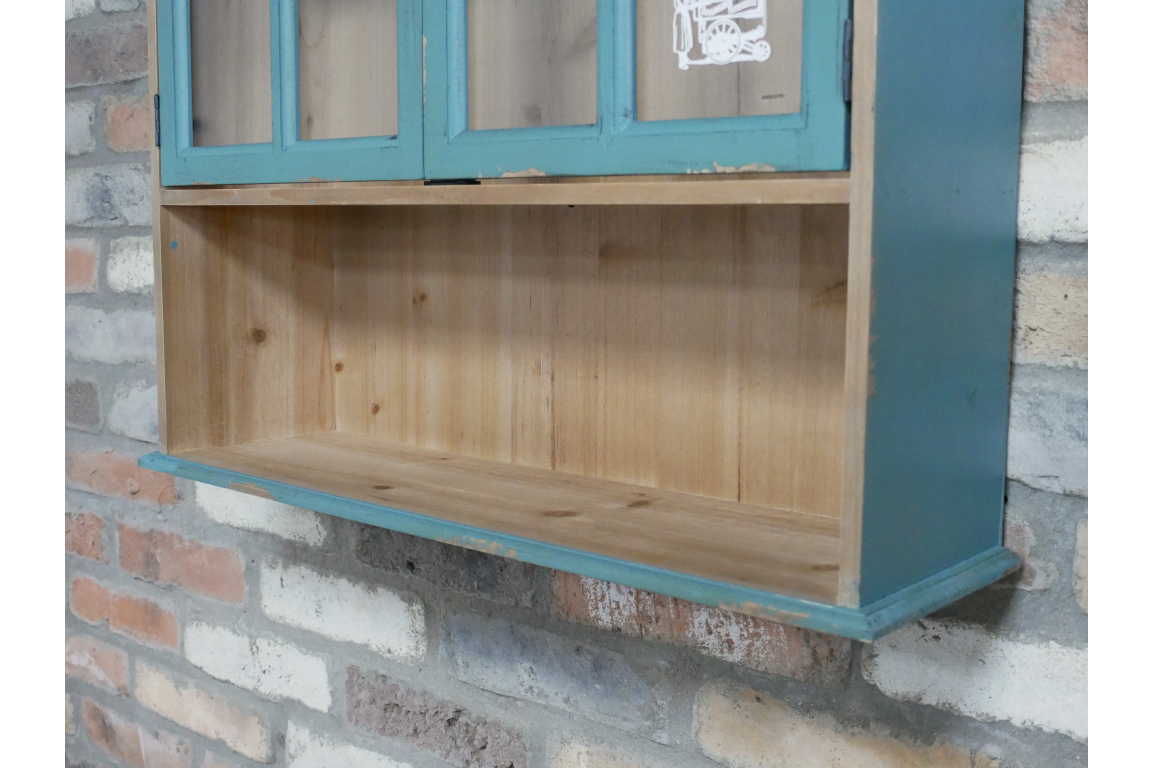 Parisienne wall unit in natural wood and distressed teal paint, close-up angled view against brick wall background.