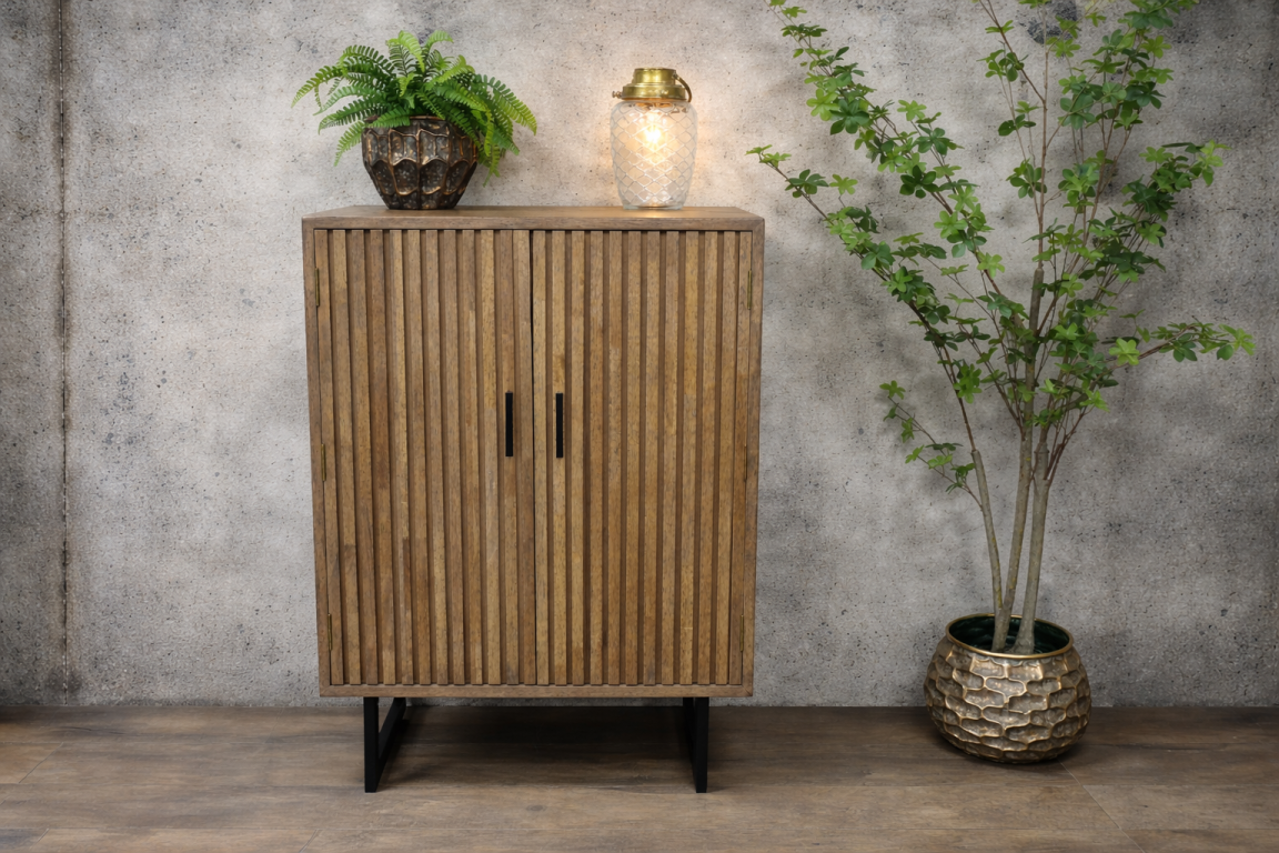 2 door slatted wooden cabinet with black metal legs, shown front view, decorated with plants and a lantern on top