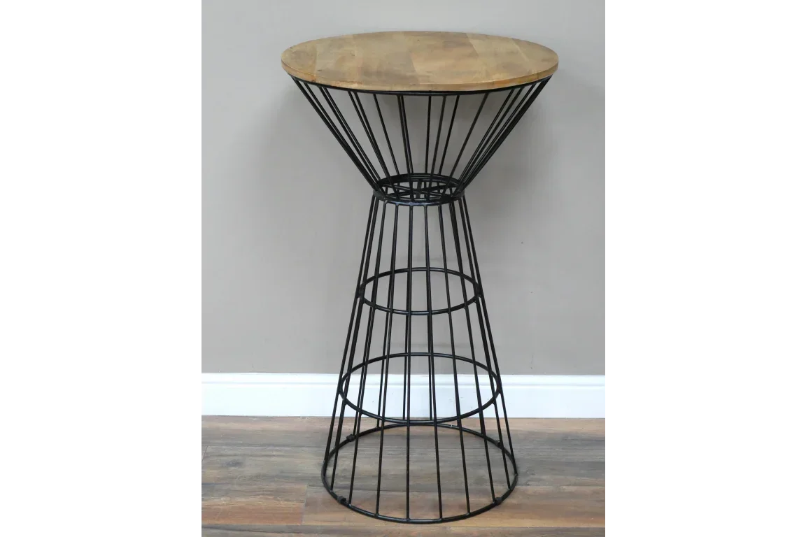 Round bar table with wooden top and black metal wire base on wood flooring