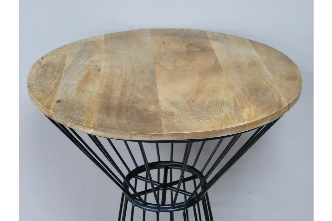Round wooden side table with black metal wire base against grey background