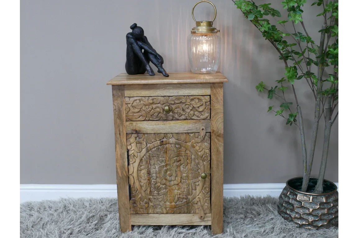 Wooden carved bedside table with one drawer and cabinet, styled with lamp and decor figurine