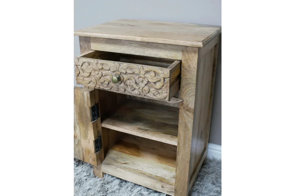Mango wood bedside cabinet with carved drawer, open shelf and door on grey rug