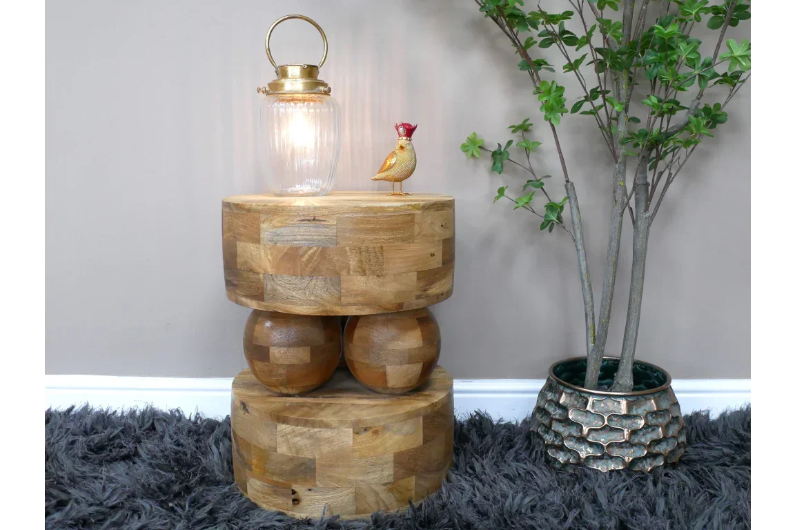 modern solid wood side table with geometric shapes, lamp and decor, beside indoor plant
