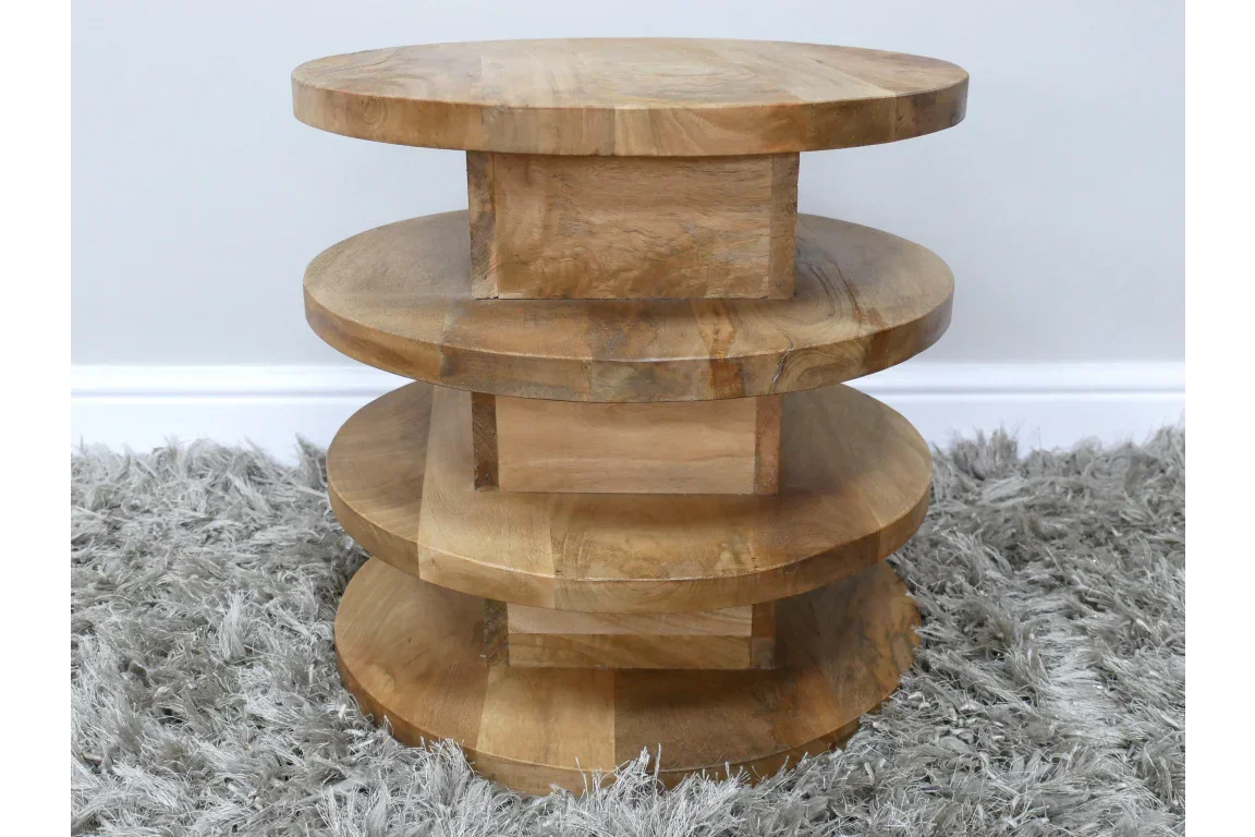 Round wooden side table with three stacked tiers on grey shaggy rug