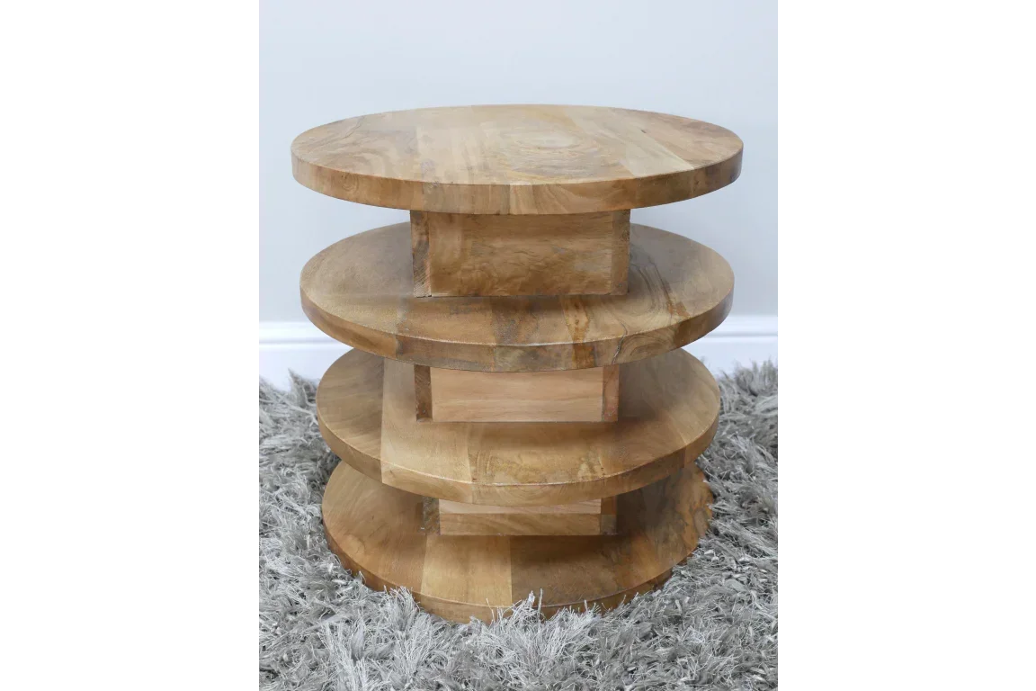 Round mango wood side table with stacked circular shelves on grey rug