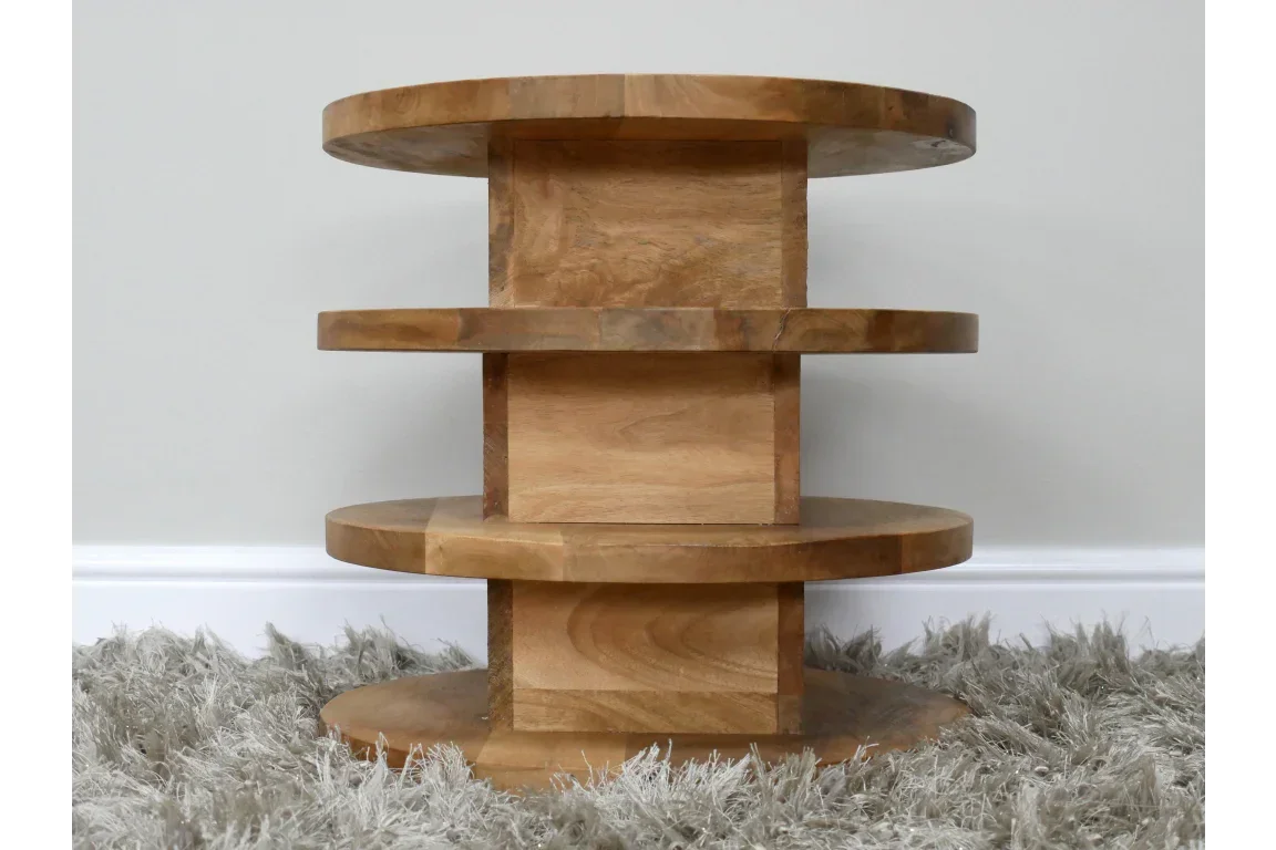 Solid wood round side table with three tier shelves on a grey rug