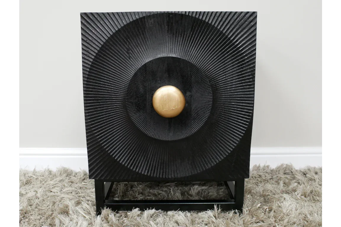 Black wooden bedside table with textured sunburst design and gold round handle