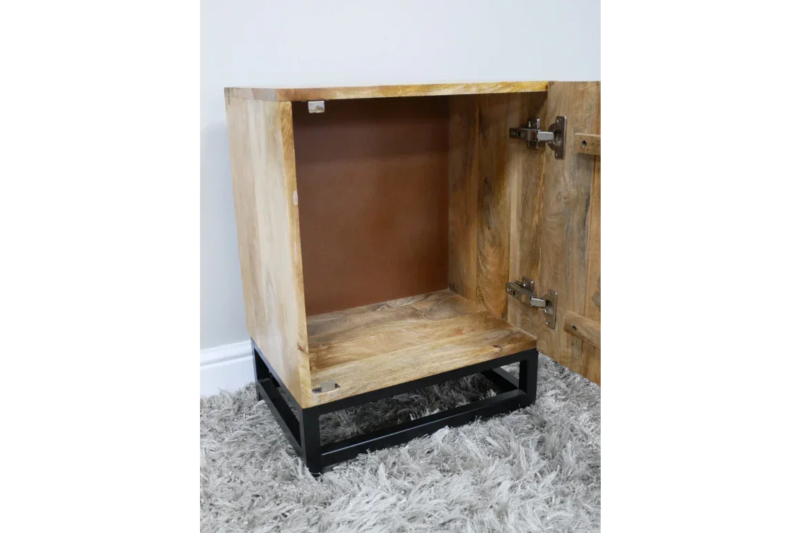 Open wooden cabinet with black metal base and visible interior hinge on carpet