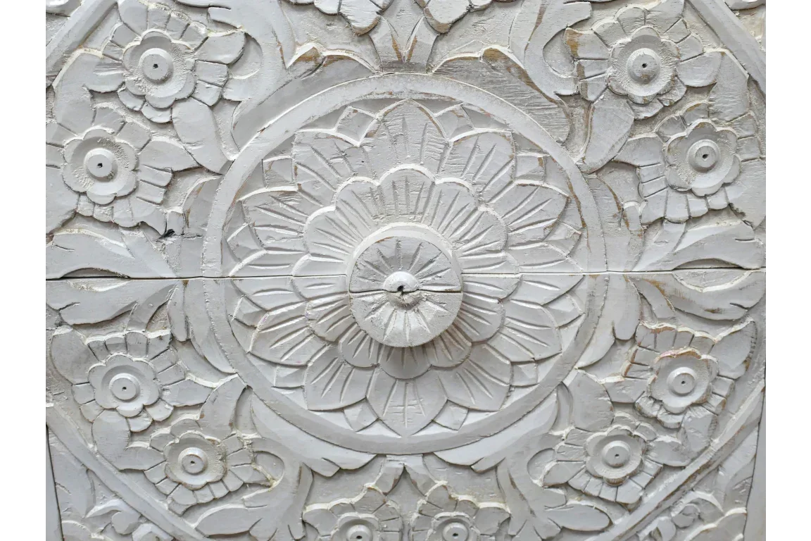 white carved wood wall panel with floral and circular mandala pattern detailing