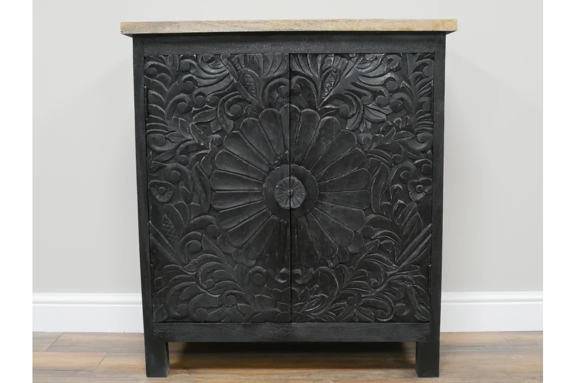 Black carved wood cabinet with floral pattern and natural wood top in front view