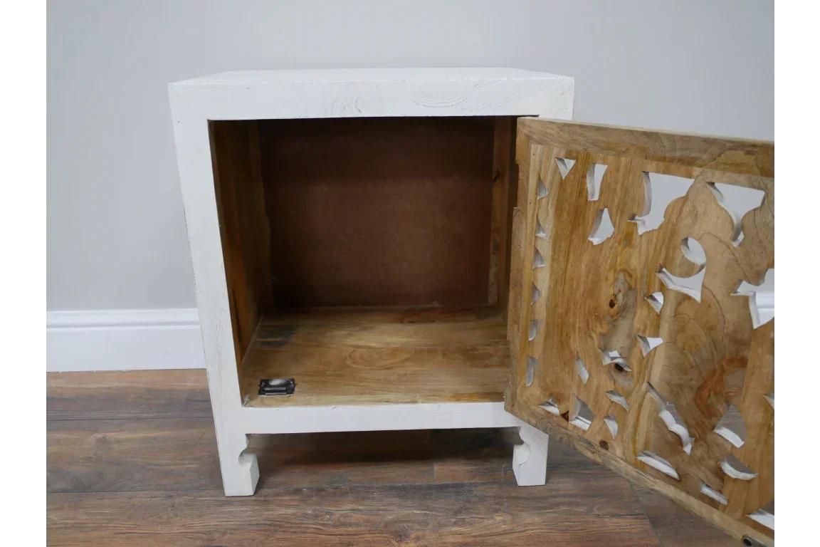 White wooden bedside cabinet with open carved door and natural wood interior