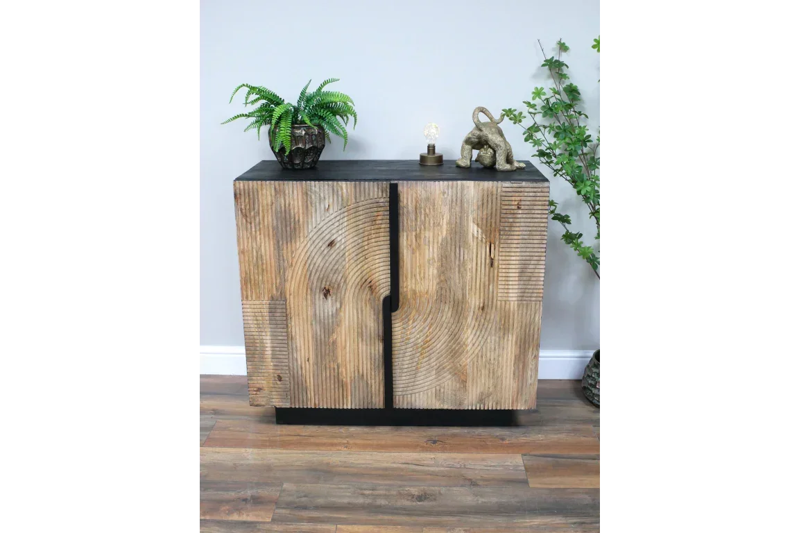 Modern wood sideboard with decorative front, black top, and plant decor in living room