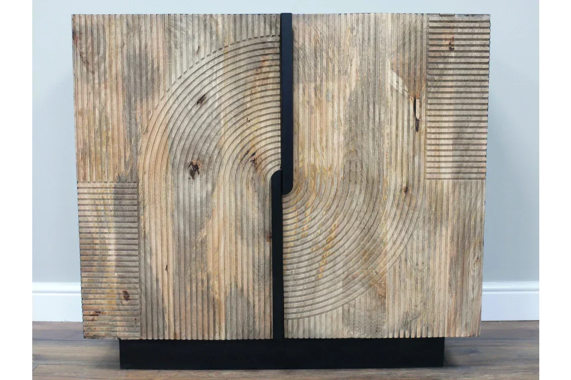 Wooden sideboard with geometric carved pattern and black base against light wall