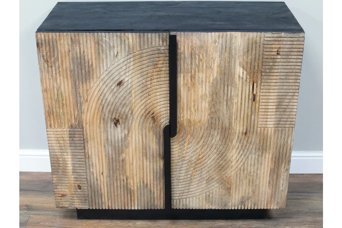 Modern wooden sideboard with carved geometric pattern and black top on hardwood floor