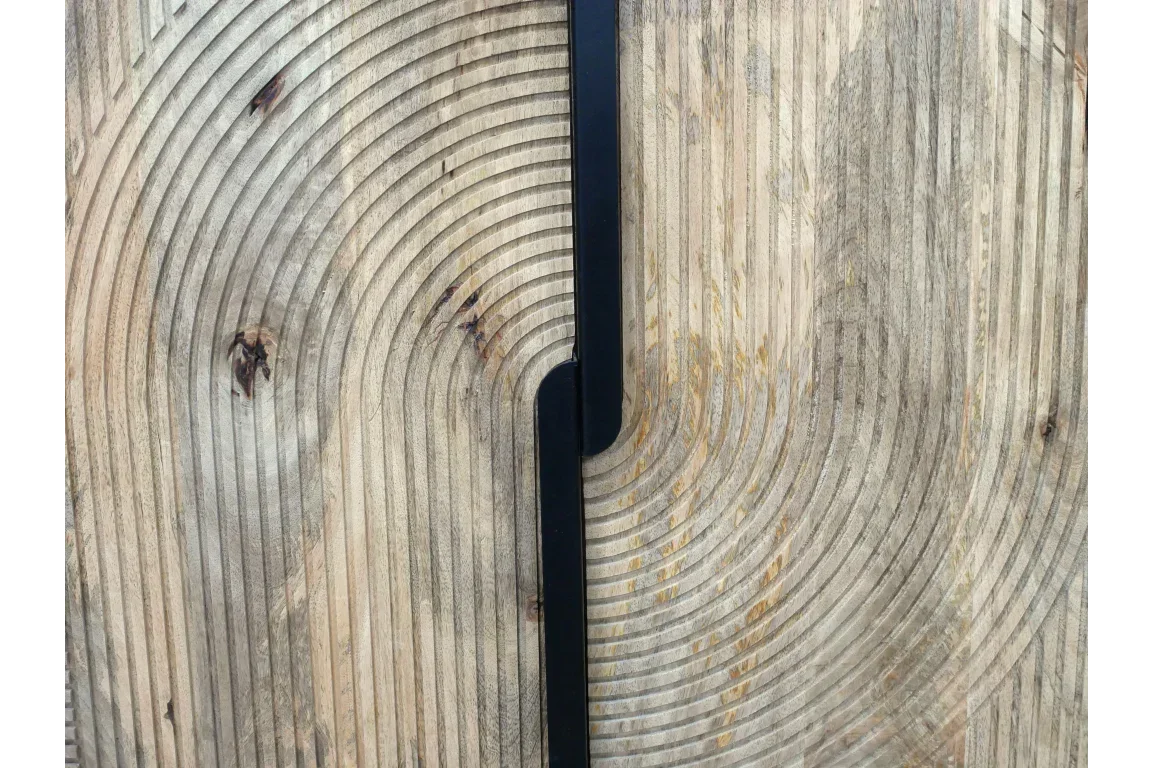 Close view of cabinet doors with grooved wood texture and black vertical handles