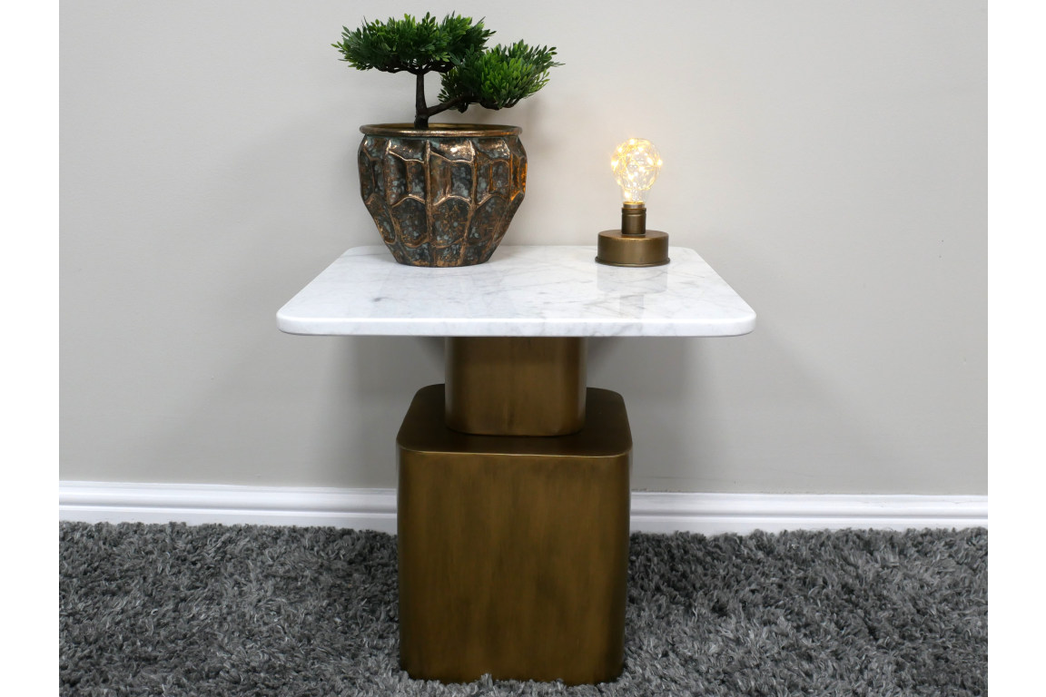 Square side table with white marble top and bronze base, shown with small potted plant and decorative light bulb on top.
