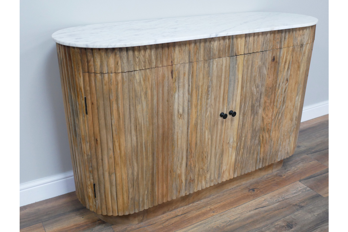 Wooden sideboard with vertical slats and white marble top, shown angled on a wooden floor against a pale wall.