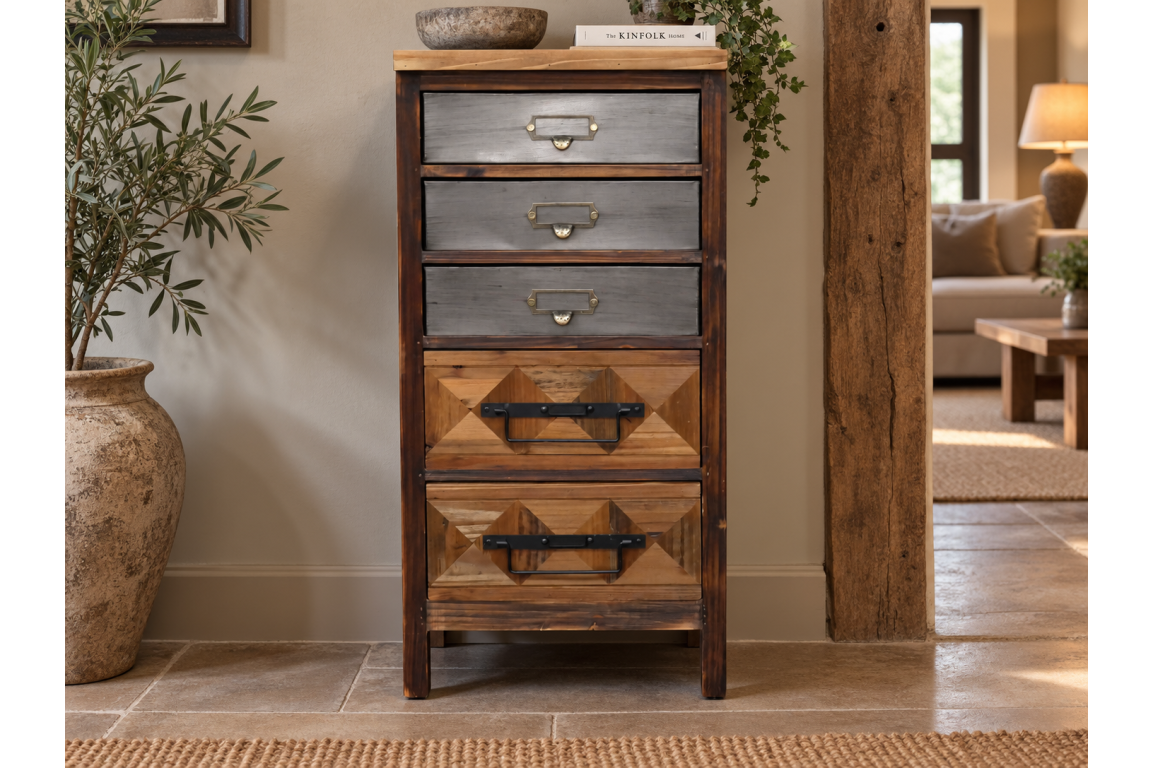 The rustic cabinet features a combination of wood and metal finishes with four drawers, showcasing a mix of geometric patterns and sturdy handles for a charming, vintage look