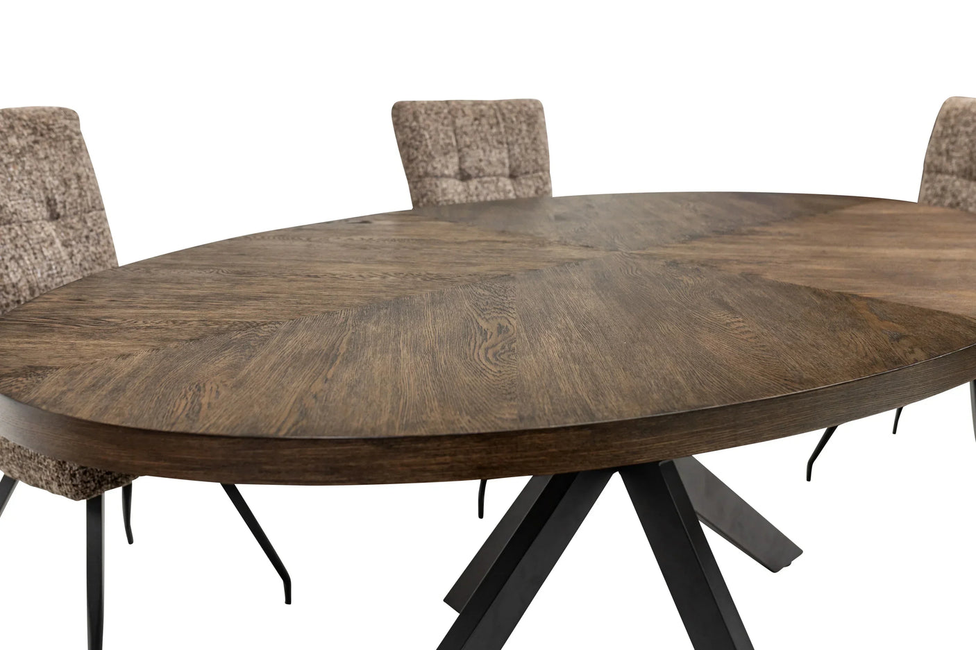 Oval wooden dining table with angled black metal legs and three fabric upholstered chairs