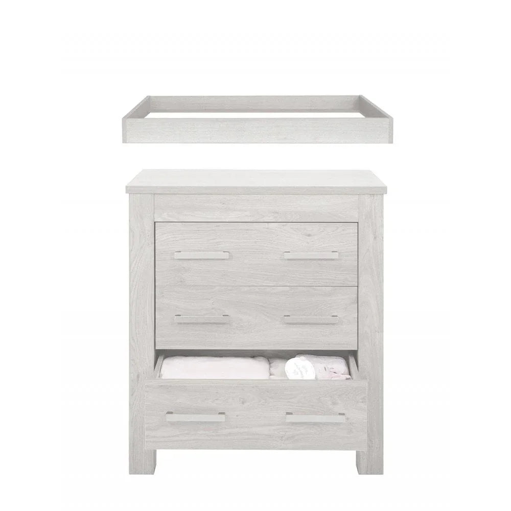 Light wood chest of drawers with open bottom drawer and removable changing top