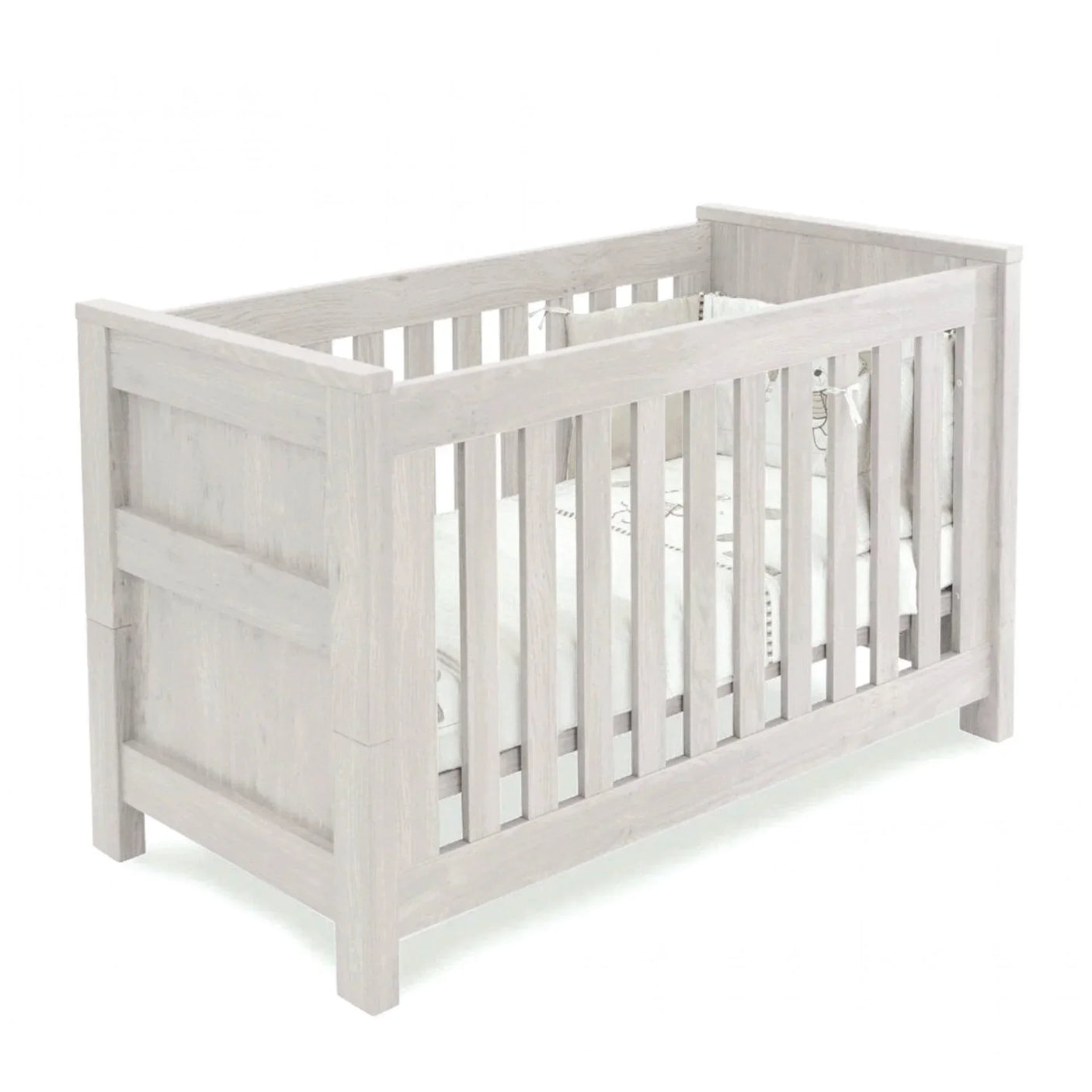 Light oak wooden cot bed with panelled sides and slatted rails, white bedding inside