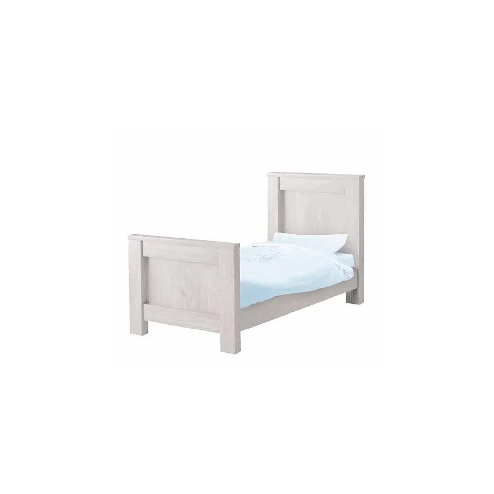 White wooden single bed frame with high headboard and footboard, light blue bedding