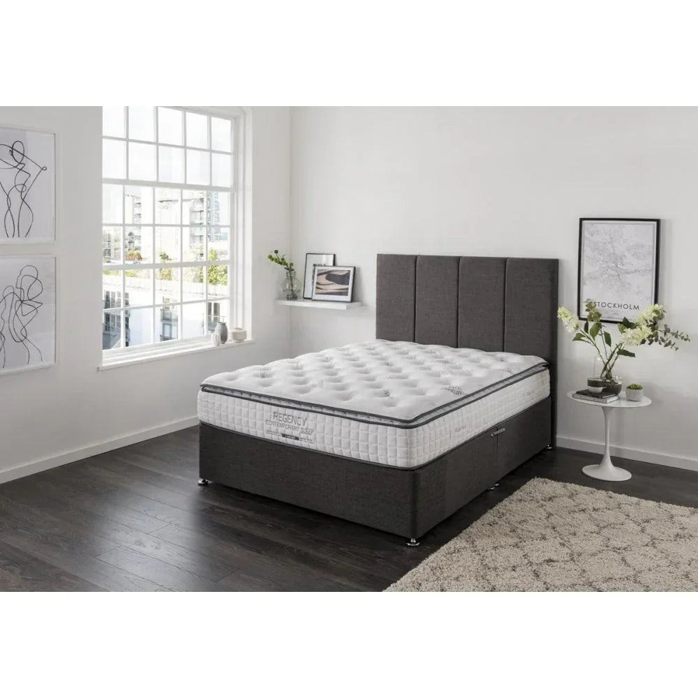 Grey fabric bed frame with headboard and white mattress in modern bedroom setting