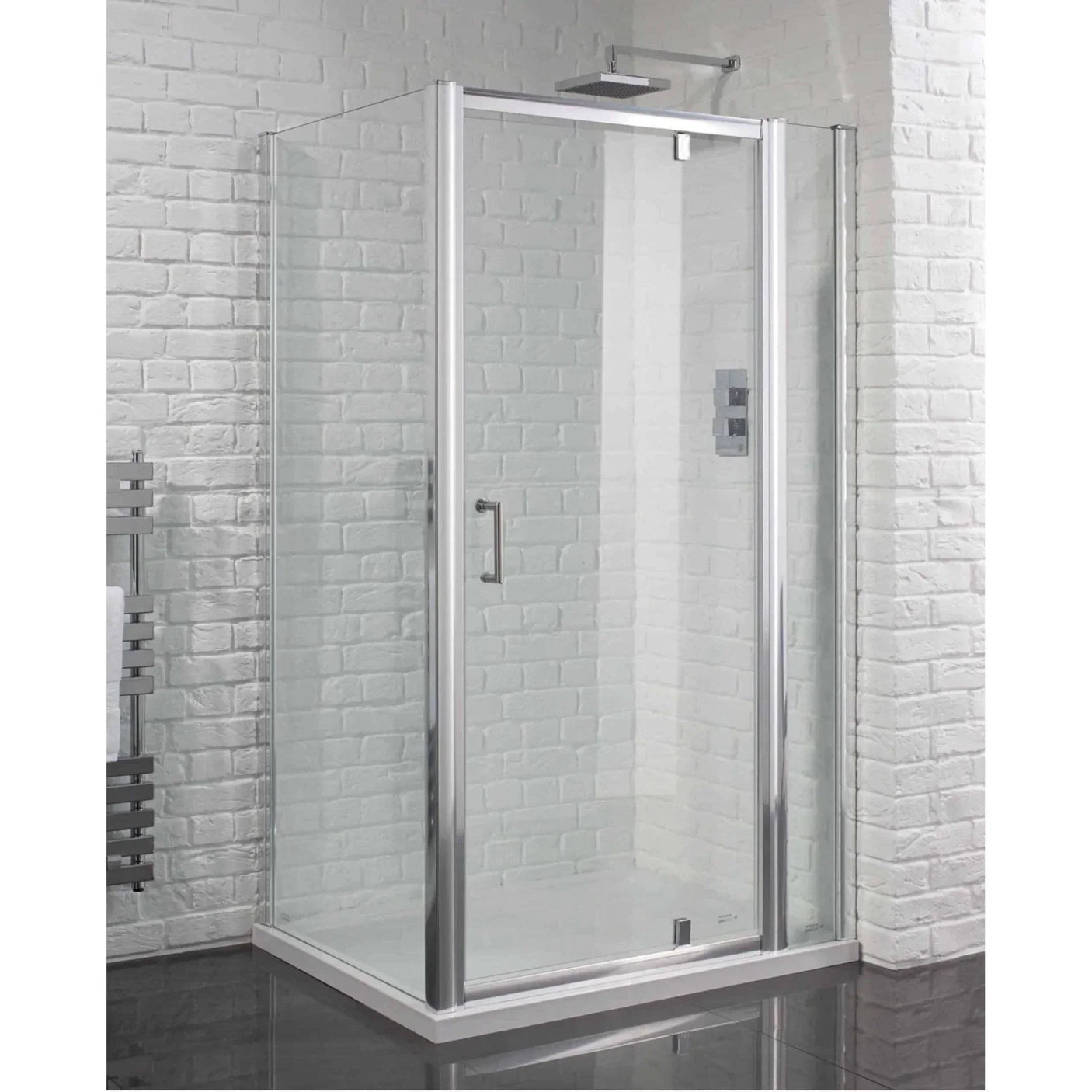 Modern glass shower enclosure with chrome frame against white brick wall