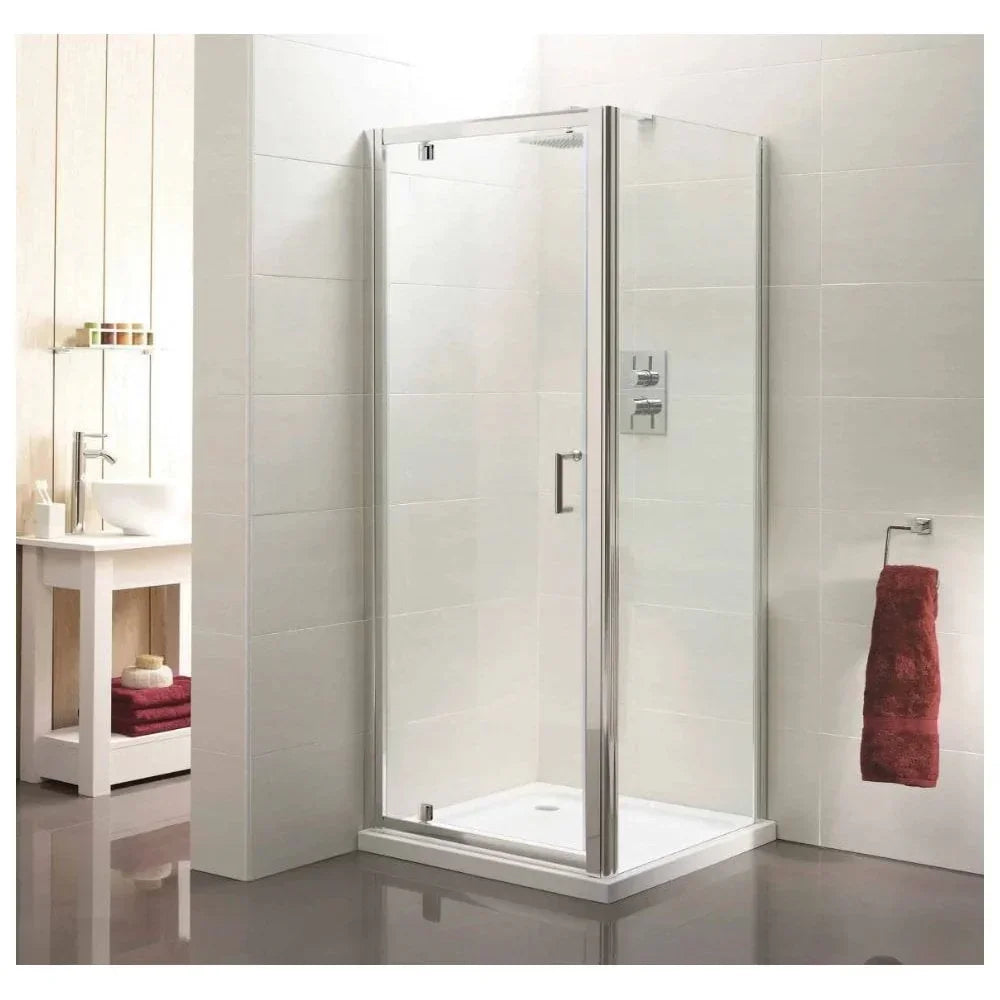 Glass shower enclosure with chrome frame in modern bathroom with white tiles