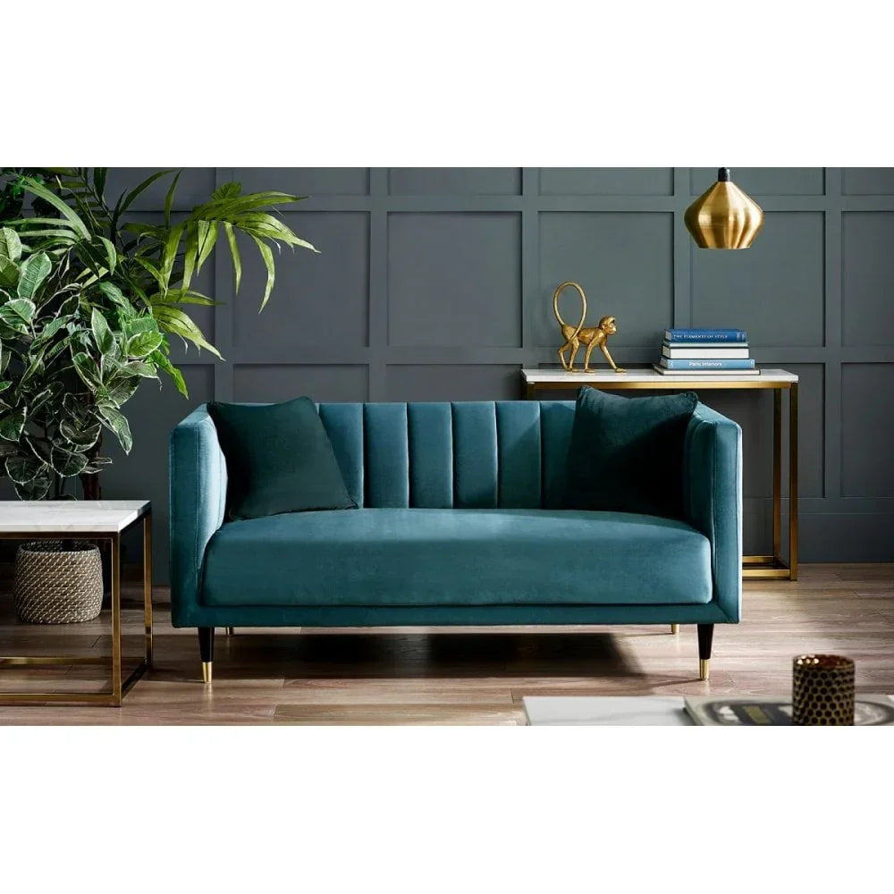 Velvet teal sofa with vertical channel tufting in modern living room setting