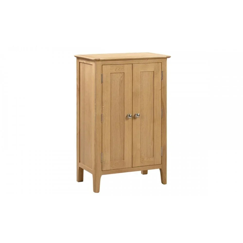 Two door oak cabinet with silver knobs and panel detailing on legs