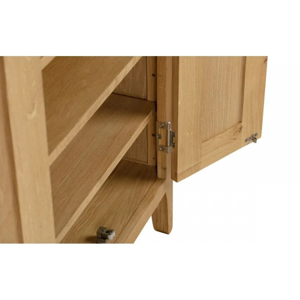 Oak sideboard unit with open cabinet door showing internal shelves and metal hinges
