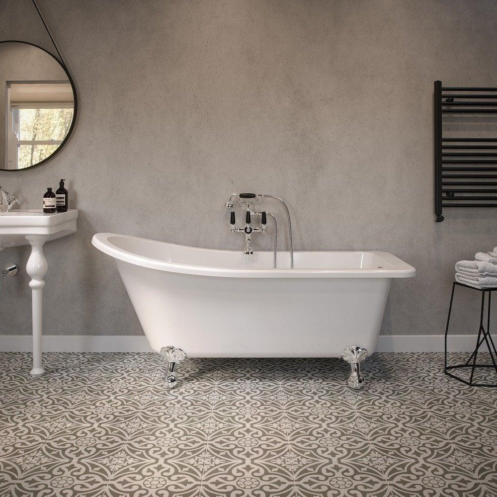White freestanding bath with chrome feet in modern bathroom with patterned floor tiles