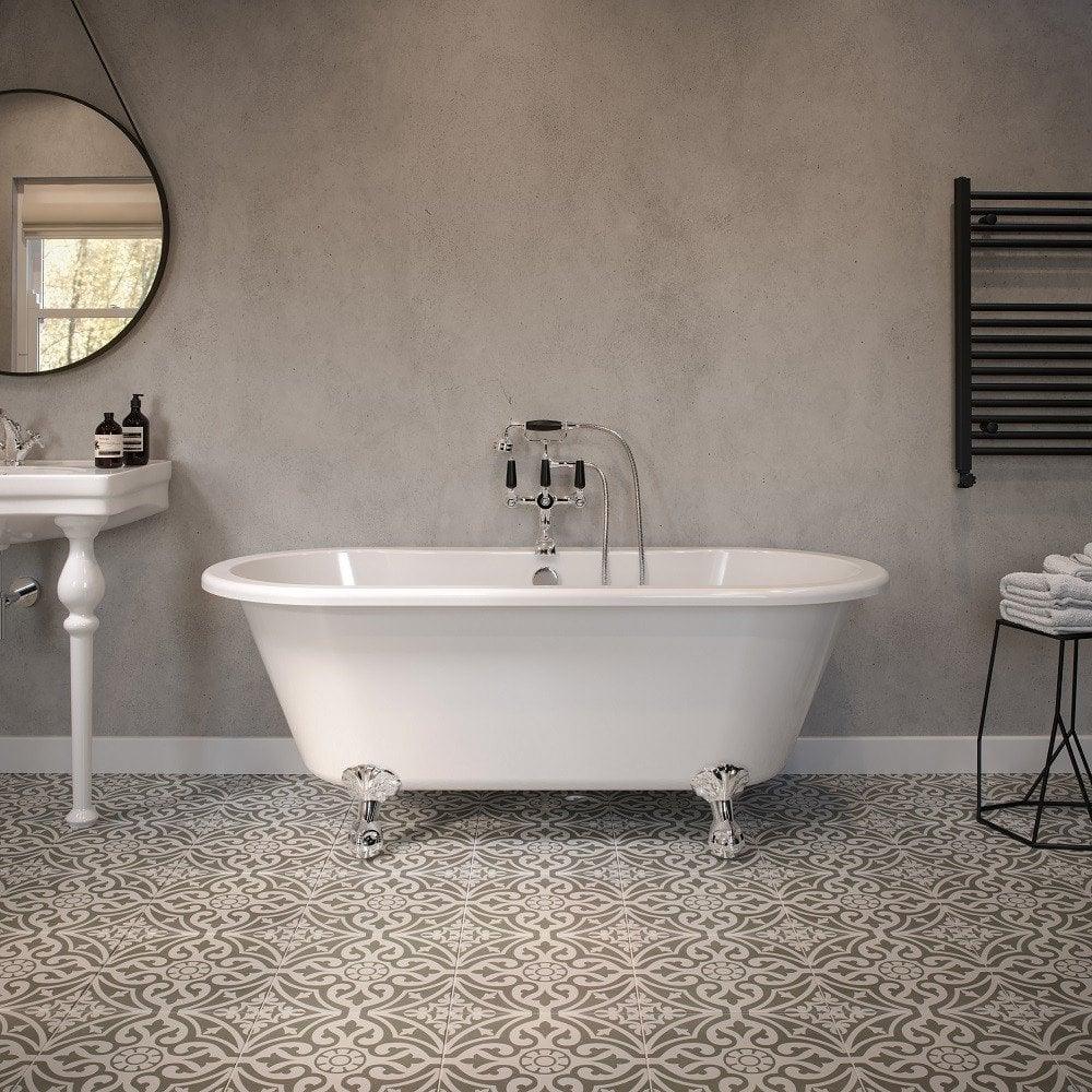 Freestanding white bath with chrome feet in modern bathroom with patterned tile floor