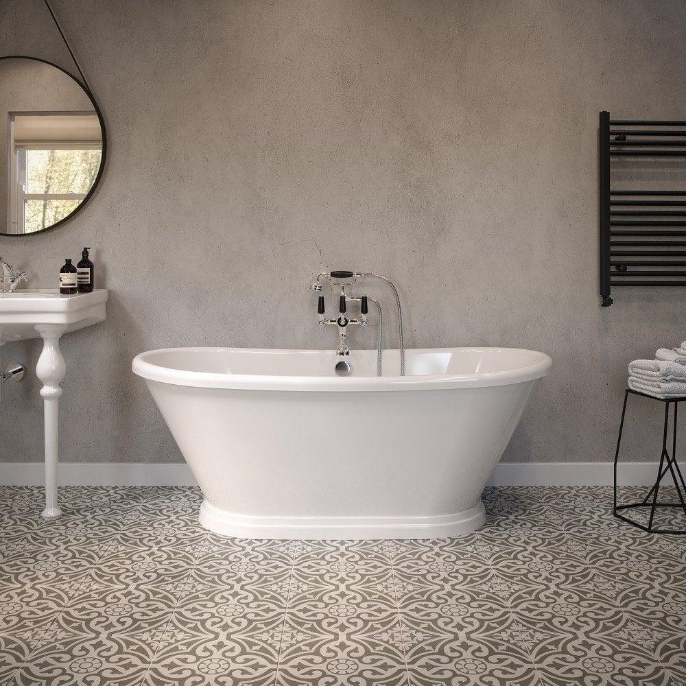 Freestanding white bath with chrome tap in modern bathroom with patterned floor tiles