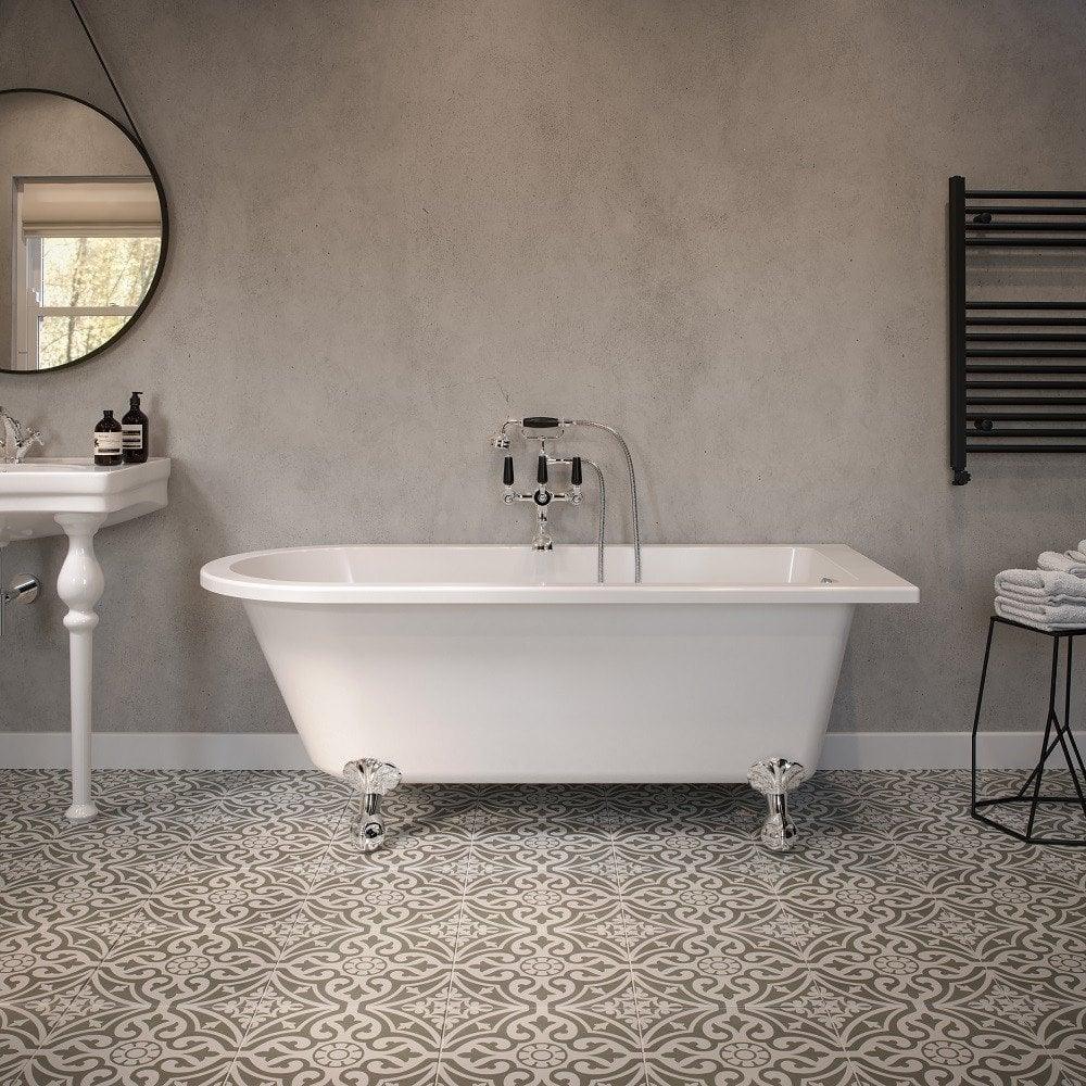 White freestanding bath with claw feet in modern bathroom with patterned floor tiles