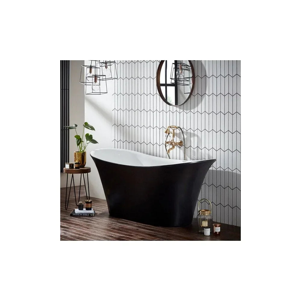 Black freestanding bathtub with gold tap in modern bathroom with geometric tile wall