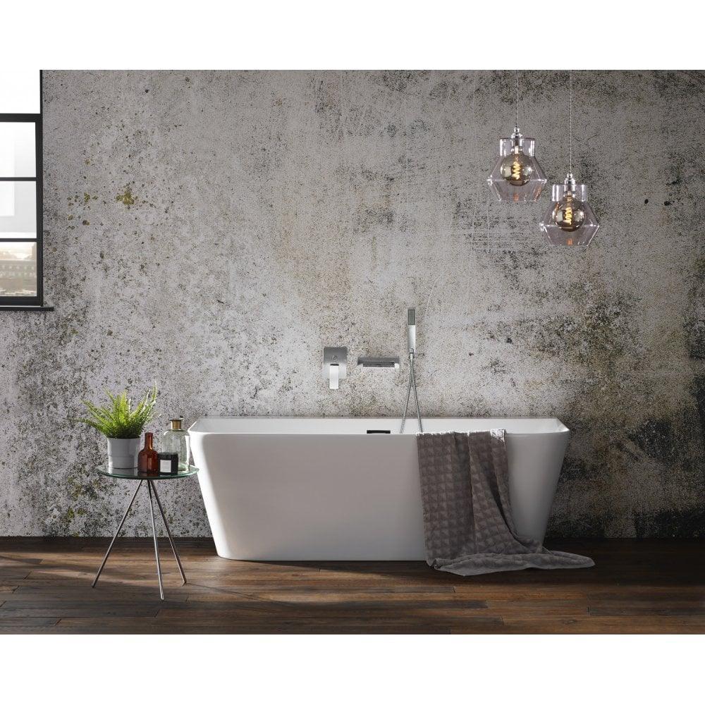 Modern freestanding bath with chrome tap, grey towel and pendant lights in industrial bathroom