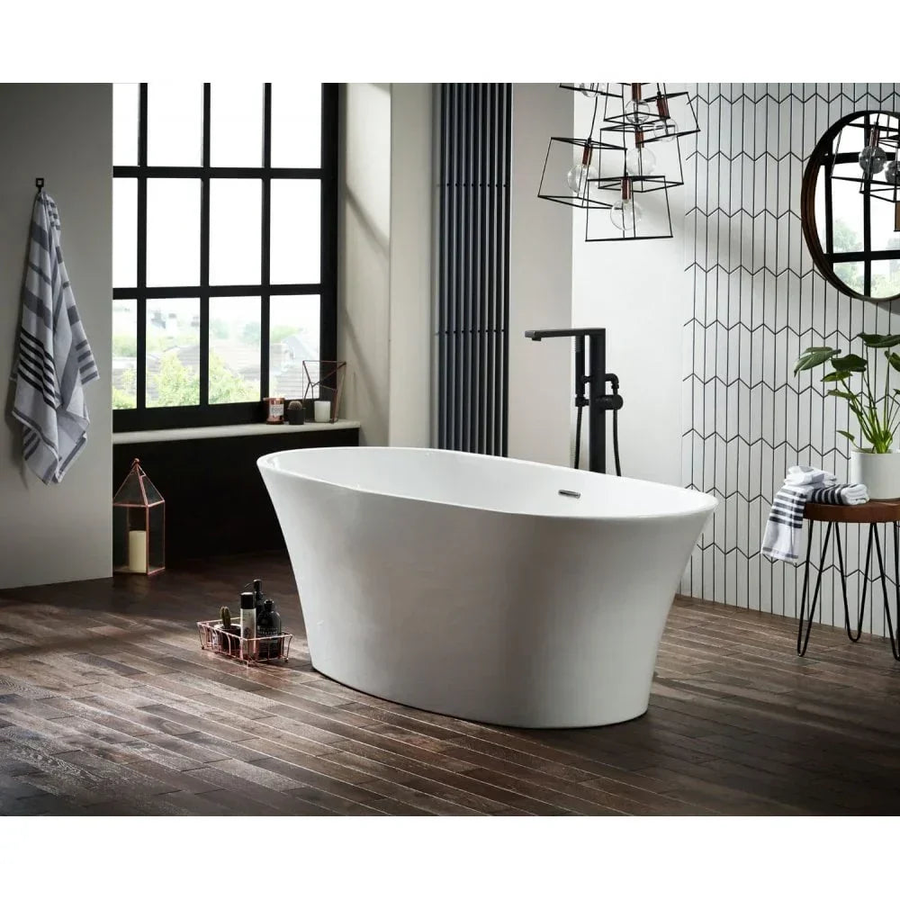Freestanding white bathtub on dark wood floor in modern bathroom with black window frame