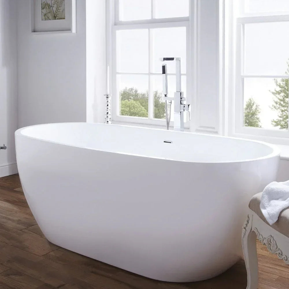 White freestanding bathtub with chrome tap in a bright bathroom with wooden flooring