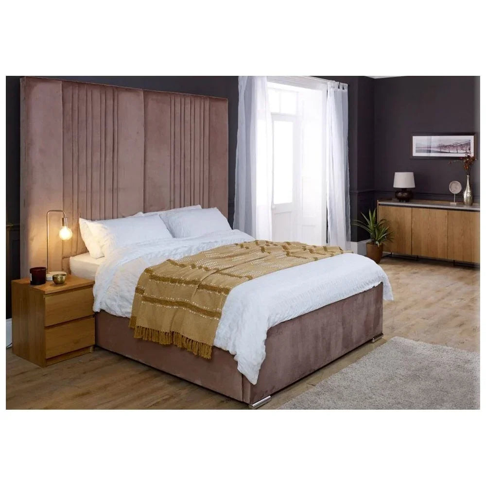 Velvet upholstered bed with tall headboard in modern bedroom, white bedding and oak nightstand