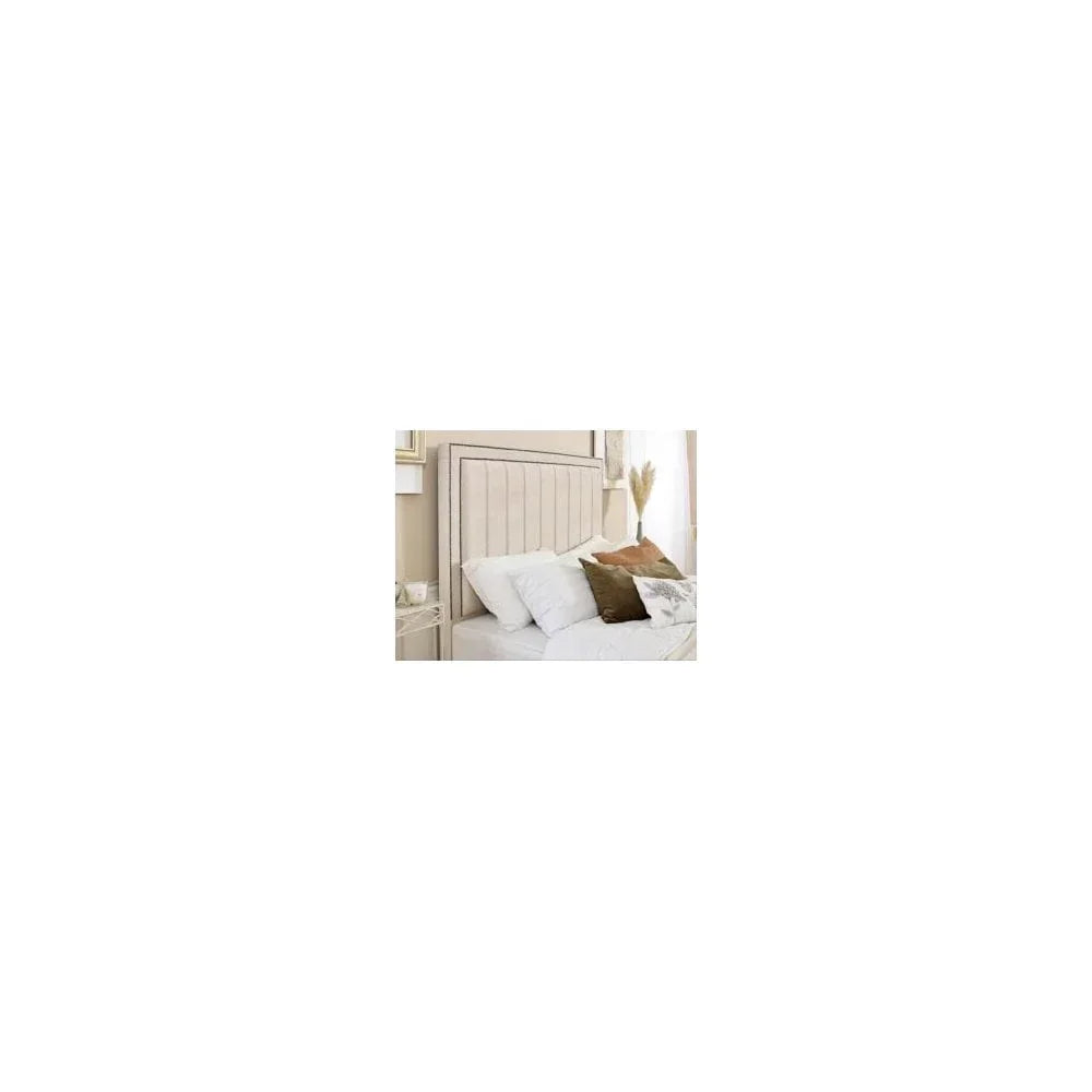 Beige upholstered bed with vertical panel headboard and accent cushions in a bright bedroom